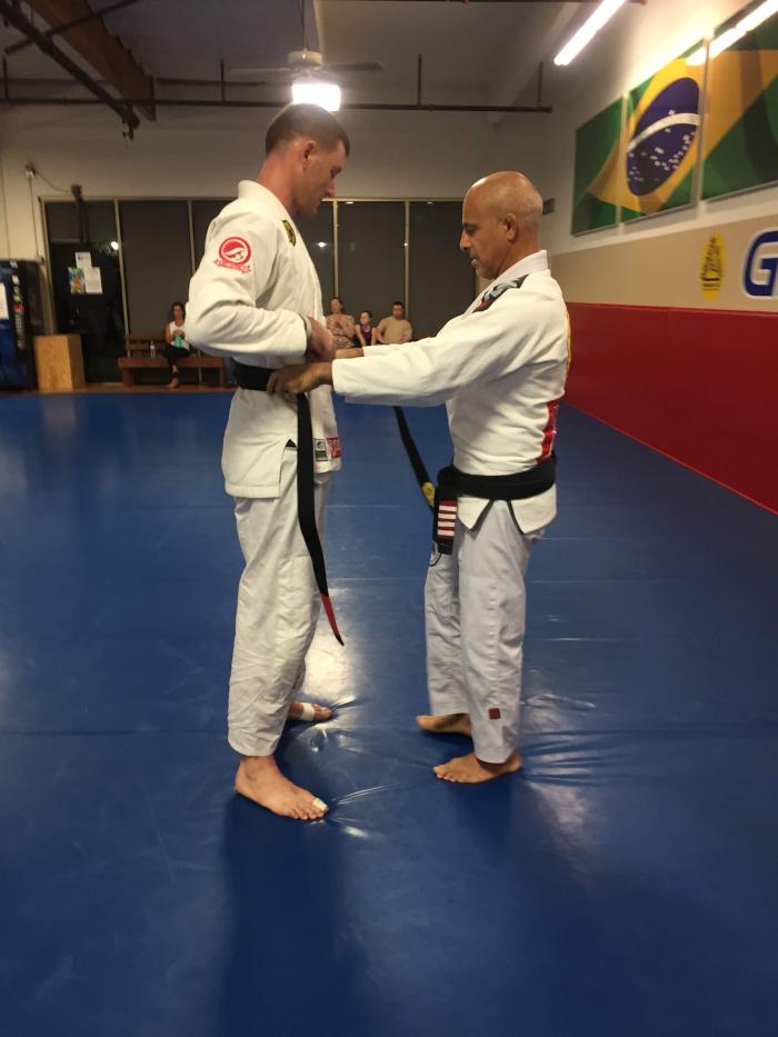 Getting promoted to black belt by Prof. Ricardo Guimarães