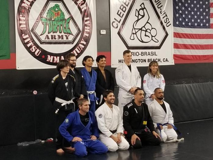 Merced Academy of Jiu Jitsu school photo after promotions. School affiliations clearly shown on wall behind our group. As stated in profile bio.