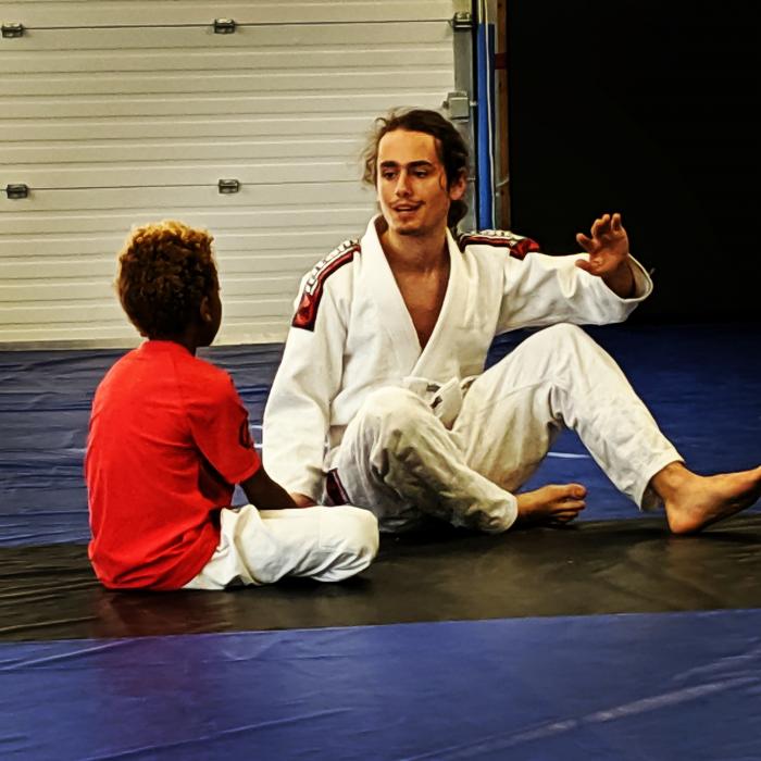 The eldest one helping out in the kids class.