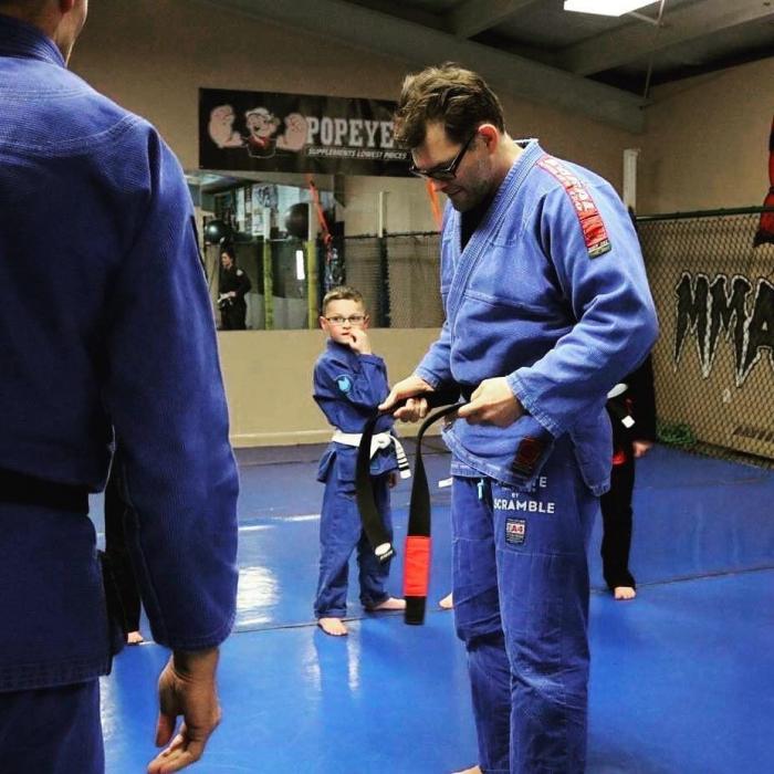 Tying on my black belt for the first time