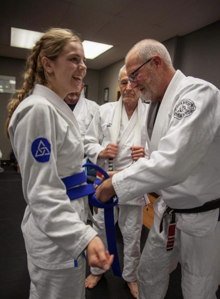 Scott Thompson putting my blue belt on me!