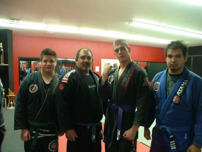 My dad, my brother, and I with Ultimate Fighter contestant James Chaney (fought out of our academy) the night of his purple belt promotion