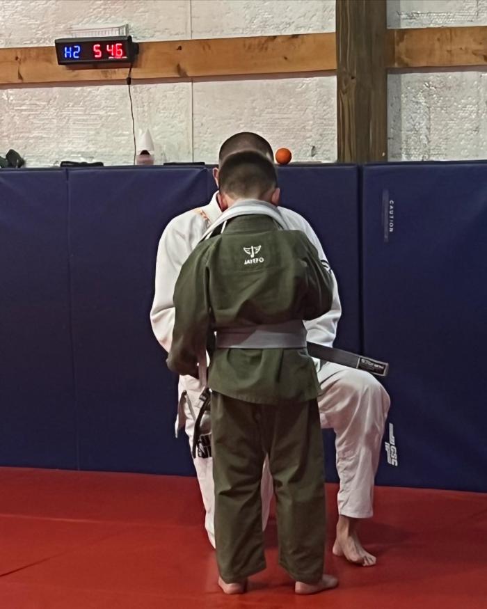 My Son being promoted to Grey belt by our coach Clint Hooper