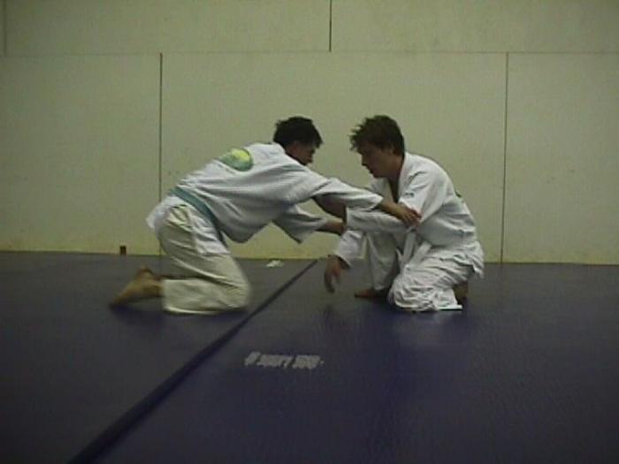 Me, white belt, and "Sonic" training on old wrestling mats in a racquetball court in 1999