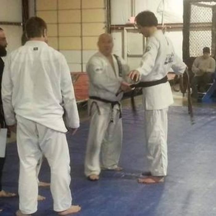 Getting promoted as Carlson Jr ties on my black belt