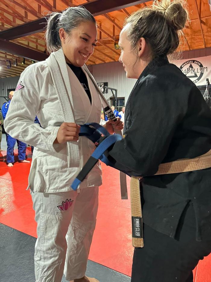 Coach Tori Brown tying on that blue belt