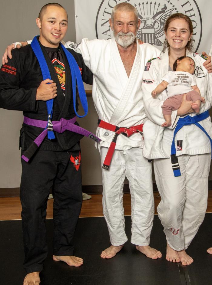 My wife, my child, Fabio Santos and me with a crisp new purple belt