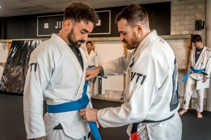 Receiving my blue belt from Coach Zac at VT1