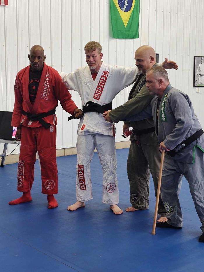 Professors Brad Scott (cmjj head instructor), Gordon Chapin, and Guy Schnitzler tying on my blackbelt.