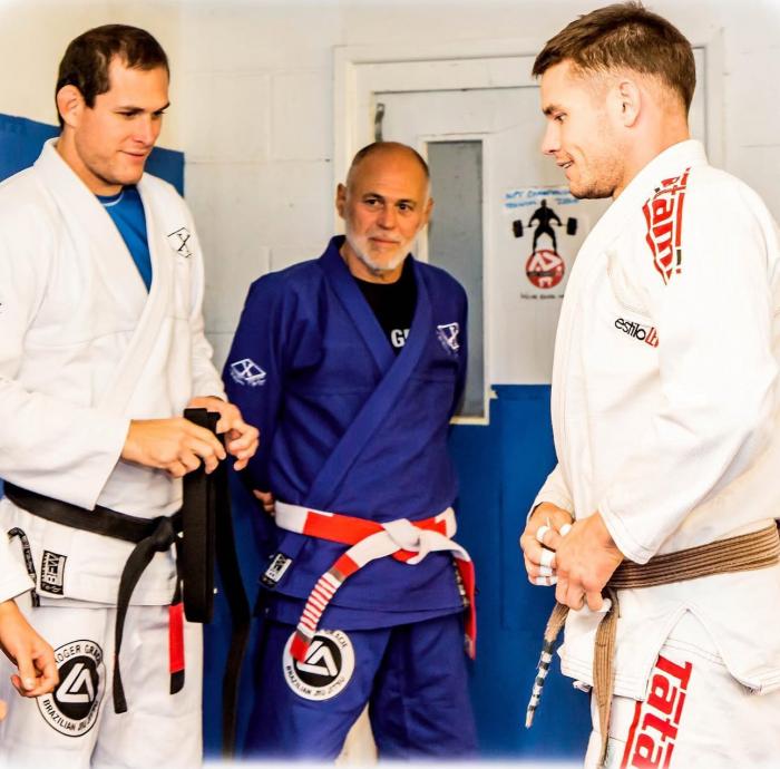 Coach Dan receiving his BB from Andy Roberts, Roger Gracie and Mauricio Gomes in 2017