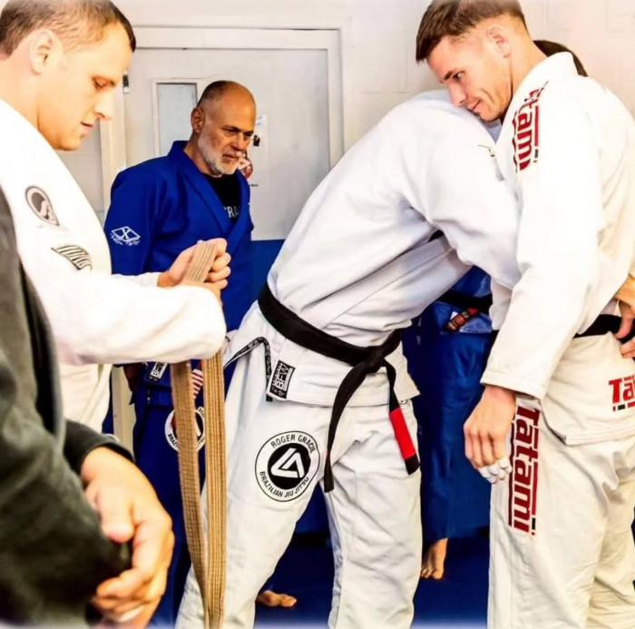 Coach Dan receiving his BB from Andy Roberts, Roger Gracie and Mauricio Gomes in 2017
