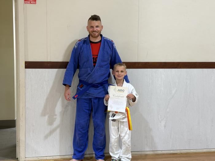 Judo blue belt with my son earning his orange/yellow belt