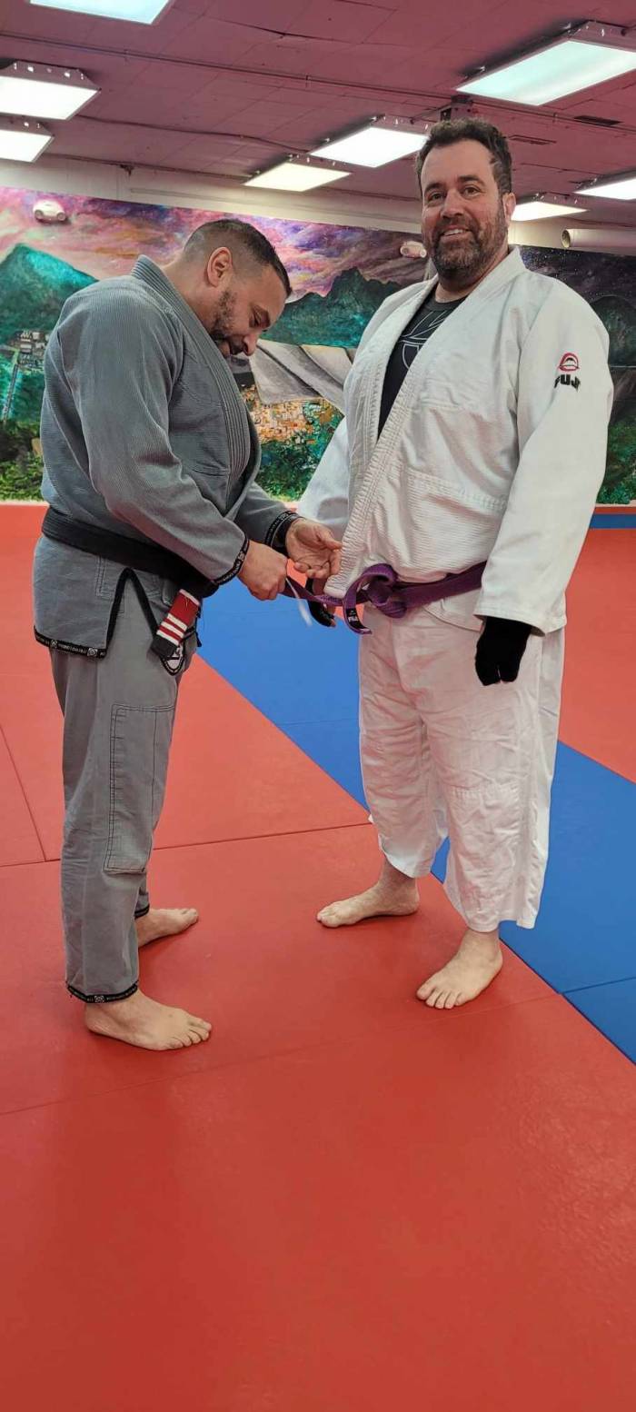 My coach Luis Rosa giving me a stripe on my purple belt a few years ago.