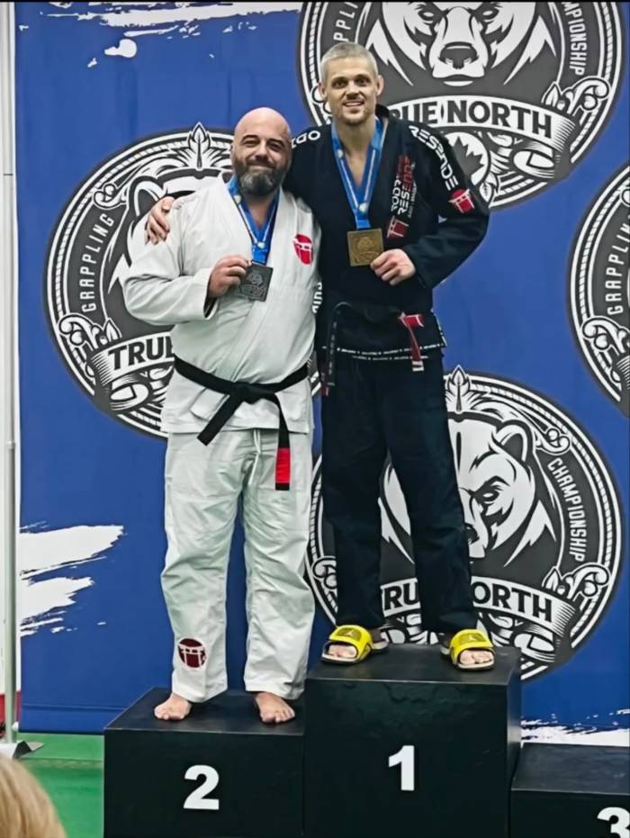 Gold medal at open weight division, submission by triangle choke.