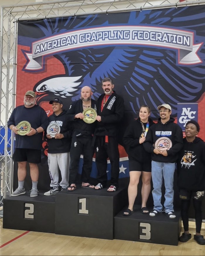 Solidarity MMA (where I train) and Patria Gloria (where I teach) teamed up to win First Place Adult Gi Team award at AGF Dallas - May 2026. Professor Justin and I accept the award.